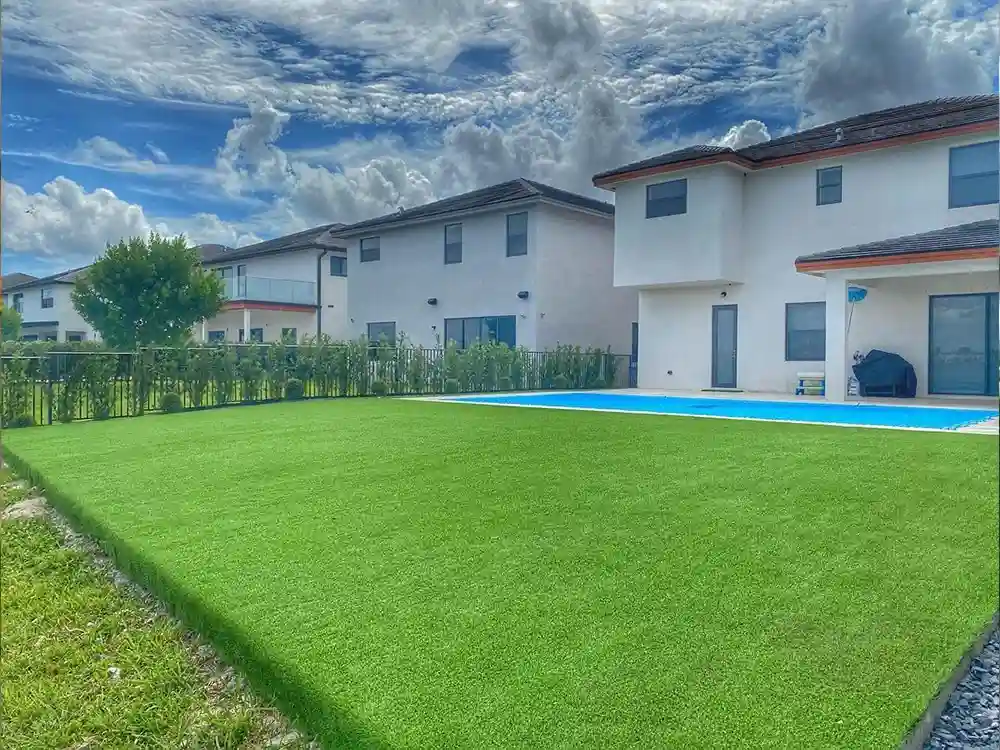 backyard and pool with top turf artificial grass around