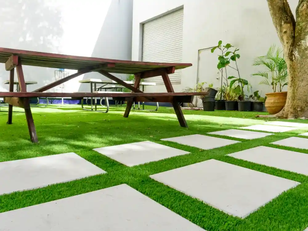 backyard with picnic table and details of artificial grass by top turf